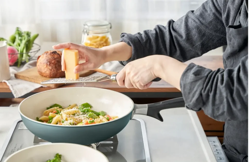 セラミックフライパンでの調理に向けて、明るいキッチンカウンターの上で野菜や食材を綺麗に並べて下準備をしている様子。